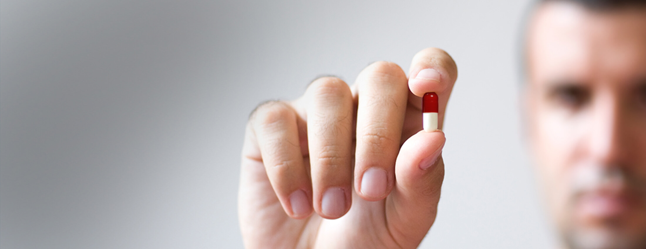 Image of hand holding pill